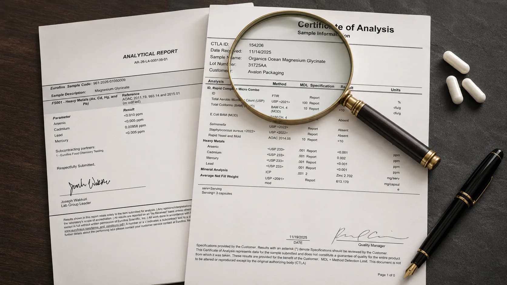 Two laboratory testing documents for Organics Ocean magnesium glycinate lying on a dark desk: a Eurofins analytical report for heavy metals and a signed Certificate of Analysis, with a magnifying glass held over the certificate's sample information, a fountain pen alongside and three capsules beside them
